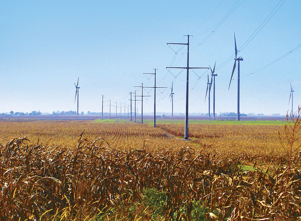 Long view of wind turbine towers in a vast field in Illinois.