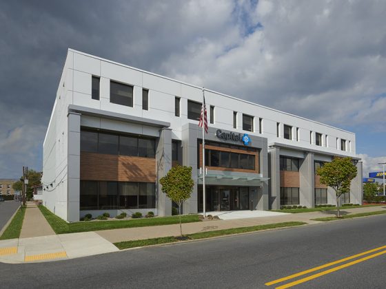 The renovated exterior of the Capital Blue Cross headquarters features modern metal panels, window screens, and louvers.