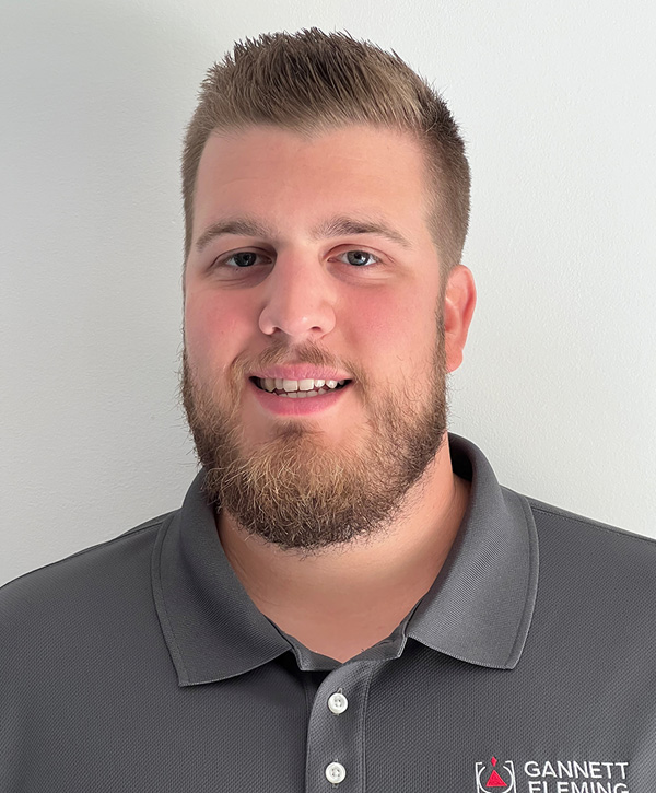 A man with facial hair smiles for the camera.