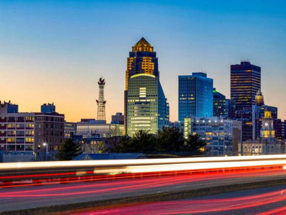 Downtown Des Moines skyline with light trails at sunset.