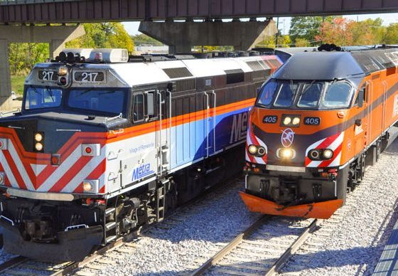 Two Metra commuter trains crossing the Fox River on the new Metra bridge.