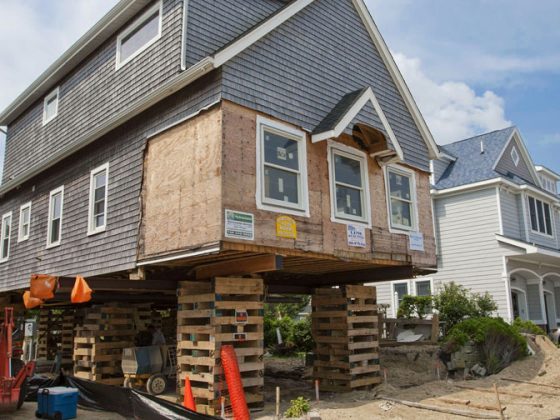 A house raised on wooden planks with some siding missing as a result of the storm. The New Jersey Reconstruction, Rehabilitation, Elevation, and Mitigation Program’s goal was to rebuild with a strong focus on enhanced resiliency.