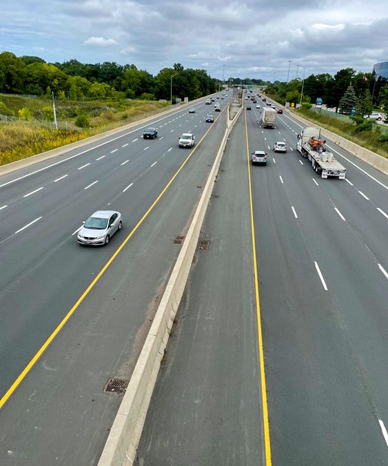 Looking down at an eight-lane highway from a bridge overpass.