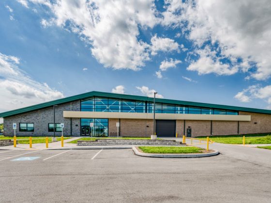 Tan brick training support center with green roof.