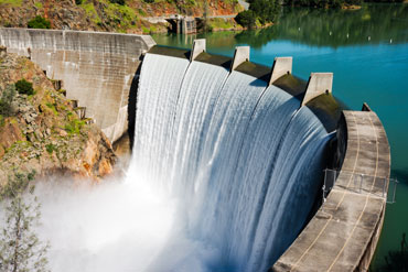 Water spills over the top of Englebright Dam on the Yuba River in California.