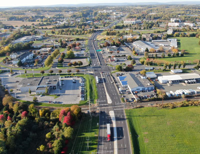 Arial view of a vertical six-lane roadway with commercial buildings along both sides. Photo courtesy of Urban Engineers.