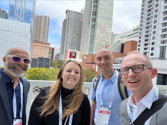 A picture of four Gannett Fleming architects in San Francisco with the city skyline in the background.