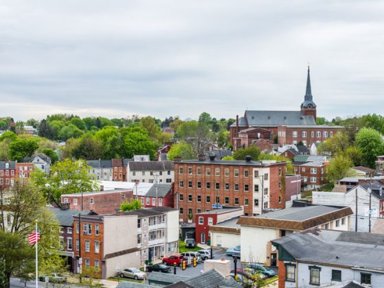 Aerial of historic downtown Lancaster, Pennsylvania, with blooming trees and brick buildings.