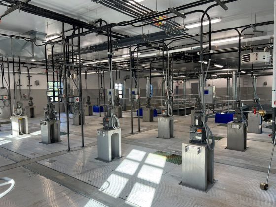 Large processing room with a series of inclined steel plates.